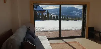 a living room with a sliding glass door with a view at Zawoja hrabkowa Jastrzębowka in Zawoja