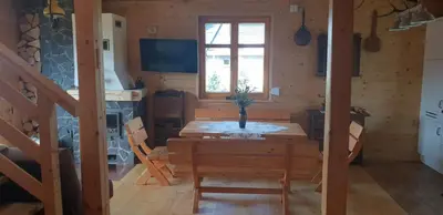 a dining room with a table and a window at Zawoja hrabkowa Jastrzębowka in Zawoja