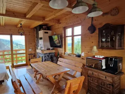 a dining room with a wooden table in a cabin at Zawoja hrabkowa Jastrzębowka in Zawoja