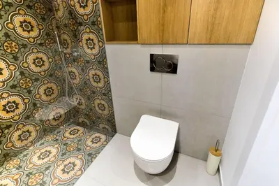 a bathroom with a toilet and a wall at apartamenty Stary Kraków GO in Kraków