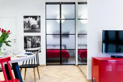 a living room with a table and a tv at apartamenty Stary Kraków GO in Kraków