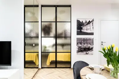 a dining room with a glass display case at apartamenty Stary Kraków GO in Kraków