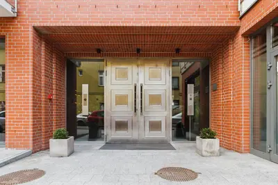 a door in a brick building with two pots at Apartments Harmonica Trynitarska by Noclegi Renters in Kraków