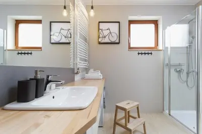a bathroom with a sink and a shower at Apartments Harmonica Trynitarska by Noclegi Renters in Kraków