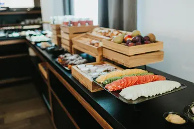 a buffet line with different types of food on at Focus Hotel Premium Kraków in Kraków