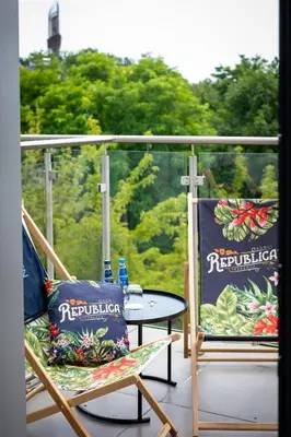 a table and chairs on a balcony with a view at Focus Hotel Premium Kraków in Kraków
