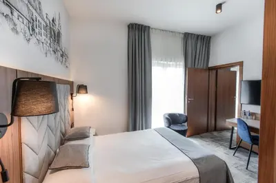 a hotel room with a bed and a desk at Focus Hotel Premium Kraków in Kraków