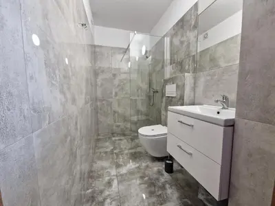 a bathroom with a white sink and a toilet at Apartamenty u Krystyny in Klikuszowa