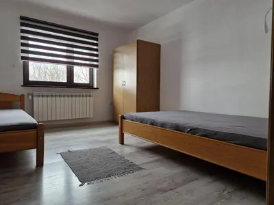 a bedroom with a bed and a window at Apartamenty u Krystyny in Klikuszowa
