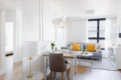 a living room with a table and a couch at Apartament Golden Place 2 in Kraków