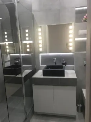 a bathroom with a sink and a mirror at Apartament VIP in Kraków