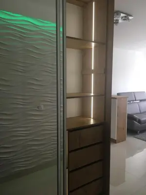 a closet with wooden shelves in a room at Apartament VIP in Kraków