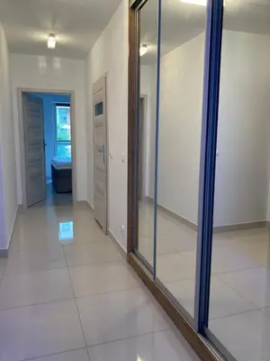 a mirror in the middle of a hallway at Apartament VIP in Kraków