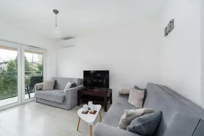 a living room with a couch and chairs and a tv at Bella Casa Premium Apartment - 104 Kobierzynska in Kraków