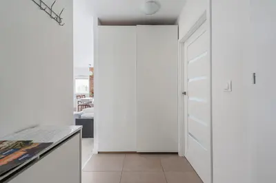 a white closet in a kitchen with a door at Bella Casa Premium Apartment - 104 Kobierzynska in Kraków
