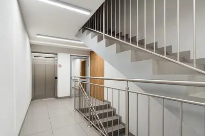 a hallway with a staircase in a building at Bella Casa Premium Apartment - 104 Kobierzynska in Kraków
