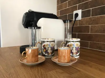 a group of four coffee cups sitting on a counter at Bella Casa Premium Apartment - 104 Kobierzynska in Kraków