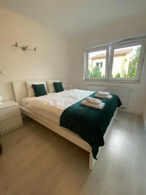 a bedroom with a large bed with two towels on it at Bella Casa Premium Apartment - 104 Kobierzynska in Kraków