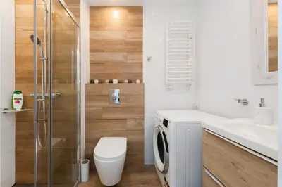 a bathroom with a toilet sink and a shower at Bella Casa Premium Apartment - 117A Kobierzynska in Kraków