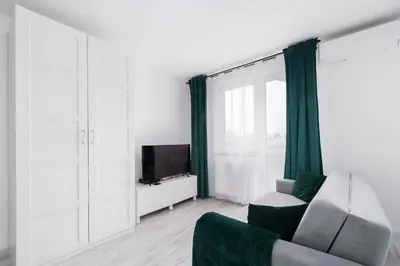 a living room with a couch and a tv at Bella Casa Premium Apartment - 117A Kobierzynska in Kraków