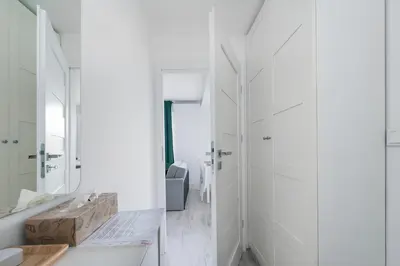 a white bathroom with a sink and a mirror at Bella Casa Premium Apartment - 117A Kobierzynska in Kraków
