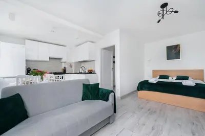 a room with a bed and a couch and a kitchen at Bella Casa Premium Apartment - 117A Kobierzynska in Kraków
