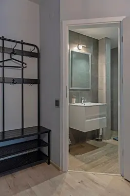 a bathroom with a sink and a mirror at Aparthotel STUDIO in Kraków
