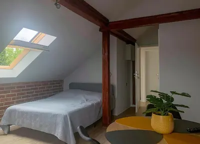 a bedroom with a bed and a table and a window at Aparthotel STUDIO in Kraków
