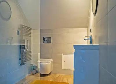 a bathroom with a toilet and a sink at Aparthotel STUDIO in Kraków