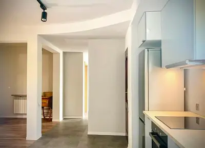 a kitchen with white walls and a counter top at Aparthotel STUDIO in Kraków