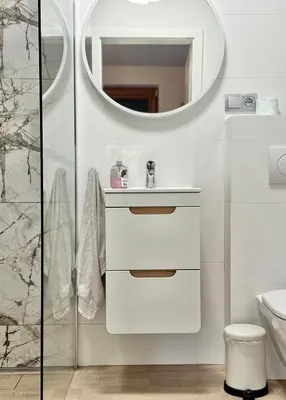 a white bathroom with a sink and a mirror at Aparthotel STUDIO in Kraków
