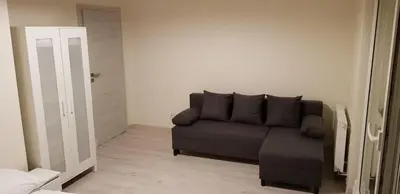 a living room with a couch and a door at Apartament Kraków Arena in Kraków