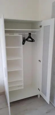 a white closet with white shelves and a door at Apartament Kraków Arena in Kraków