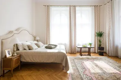 a white bedroom with a bed and a rug at Belle Epoque I, luxury suite 50m to Main Square in Kraków