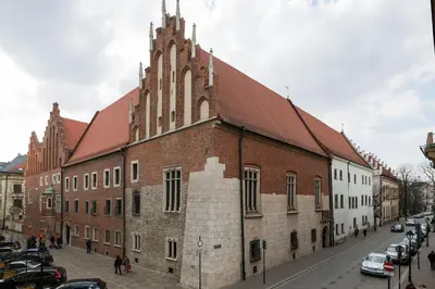a large brick building with a steeple on a street at Belle Epoque I, luxury suite 50m to Main Square in Kraków