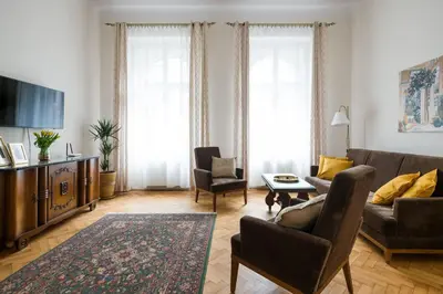 a living room with a couch and chairs and a tv at Belle Epoque I, luxury suite 50m to Main Square in Kraków
