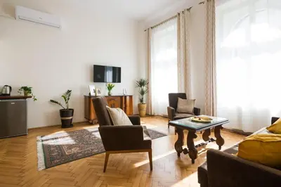 a living room with a couch and a table at Belle Epoque I, luxury suite 50m to Main Square in Kraków