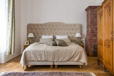 a bedroom with a large bed with two pillows at Belle Epoque II, luxury suite 50m to Main Square in Kraków