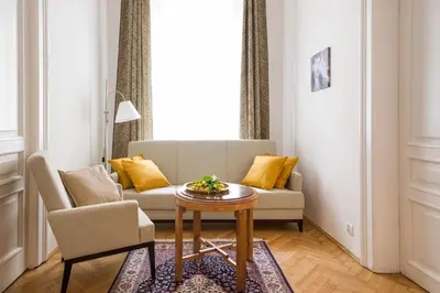 a living room with a couch and a table at Belle Epoque II, luxury suite 50m to Main Square in Kraków