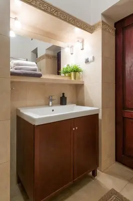 a bathroom with a sink and a wooden cabinet at Belle Epoque II, luxury suite 50m to Main Square in Kraków