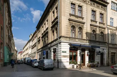 a building on a street with cars parked on the street at Belle Epoque II, luxury suite 50m to Main Square in Kraków