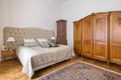 a bedroom with a large bed and a large wooden cabinet at Belle Epoque II, luxury suite 50m to Main Square in Kraków