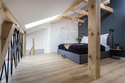 a kitchen with white cabinets and a counter with a sink at InPoint Old Town Comfort Apartments Self Check-in in Kraków