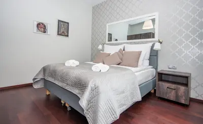 a living room with a couch and a table at InPoint Old Town Comfort Apartments Self Check-in in Kraków
