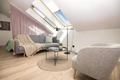 a bedroom with a large bed and windows at InPoint Old Town Comfort Apartments Self Check-in in Kraków