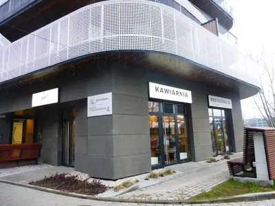 a building with a sign on the front of it at Apartament Nad Wisłą - Pianissimo in Kraków