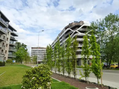 a row of trees in front of a building at Apartament Nad Wisłą - Pianissimo in Kraków