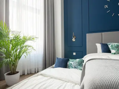 a bedroom with a bed and a blue wall at Luxury Gold Cracow City Centre 3min Main Sq Old Town in Kraków