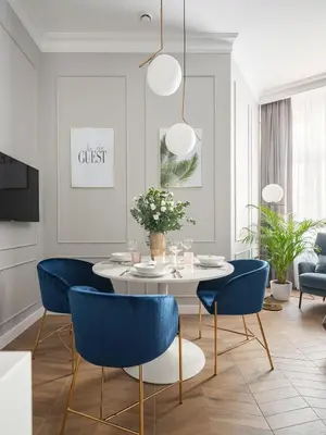 a dining room with a table and blue chairs at Luxury Gold Cracow City Centre 3min Main Sq Old Town in Kraków