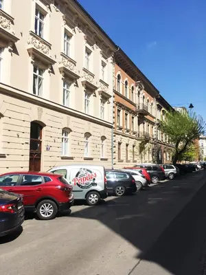 a row of cars parked in front of a building at Luxury Gold Cracow City Centre 3min Main Sq Old Town in Kraków
